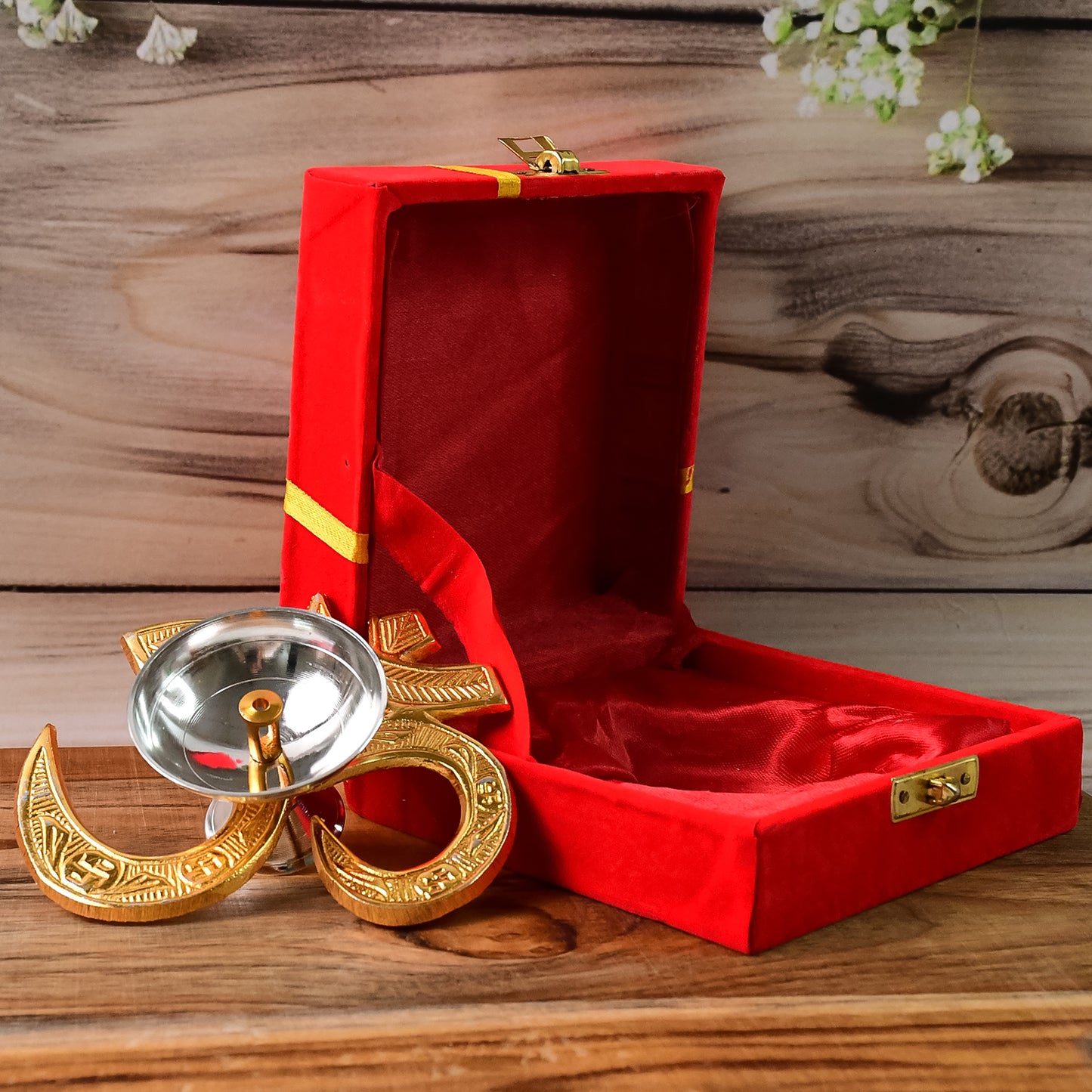 Brass Om symbol oil diya for home decor, featuring a carved Om design and a small oil reservoir, by Wukusy.