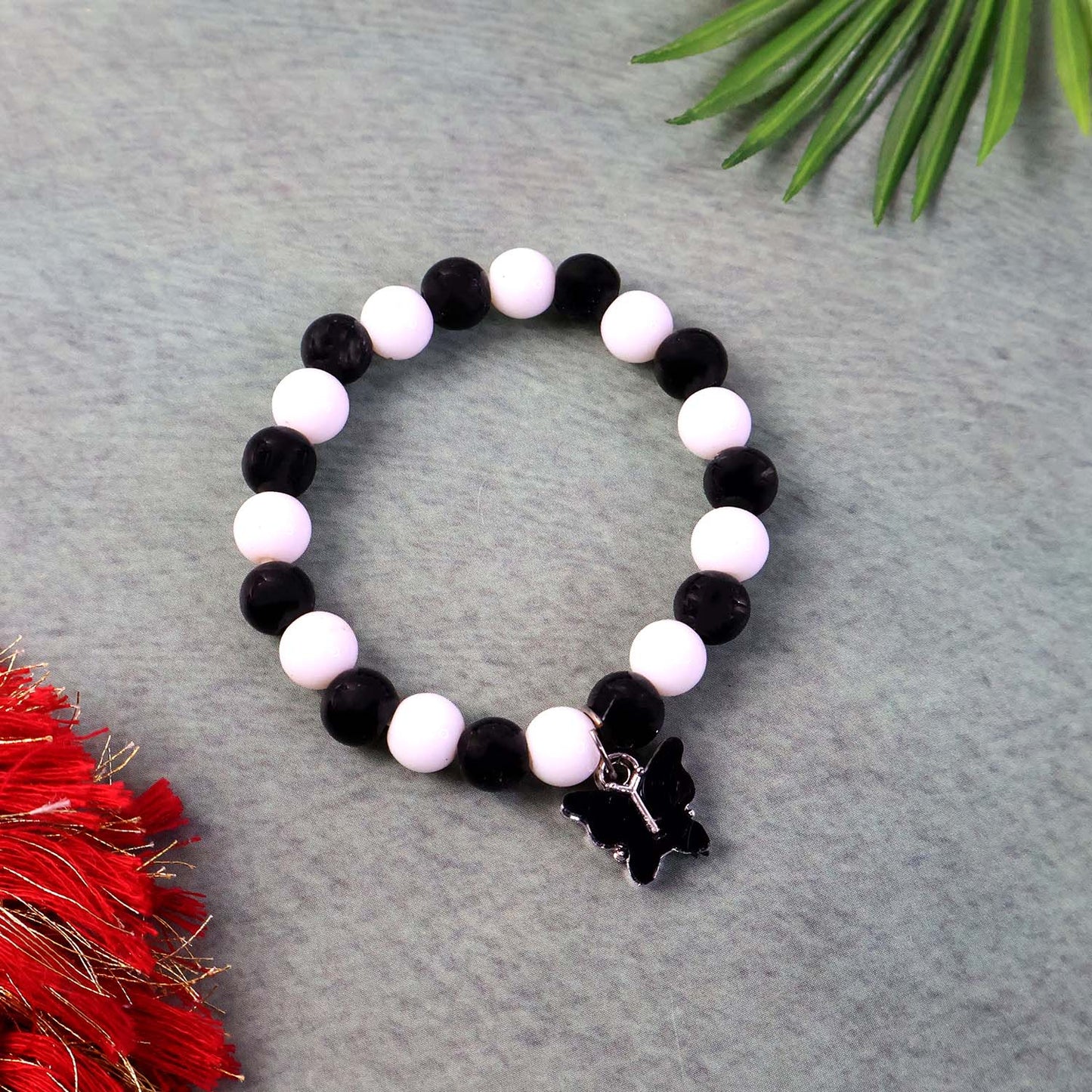 Elegant black and white fancy bracelet by Wukusy featuring intricate design and stylish appearance on a neutral background.