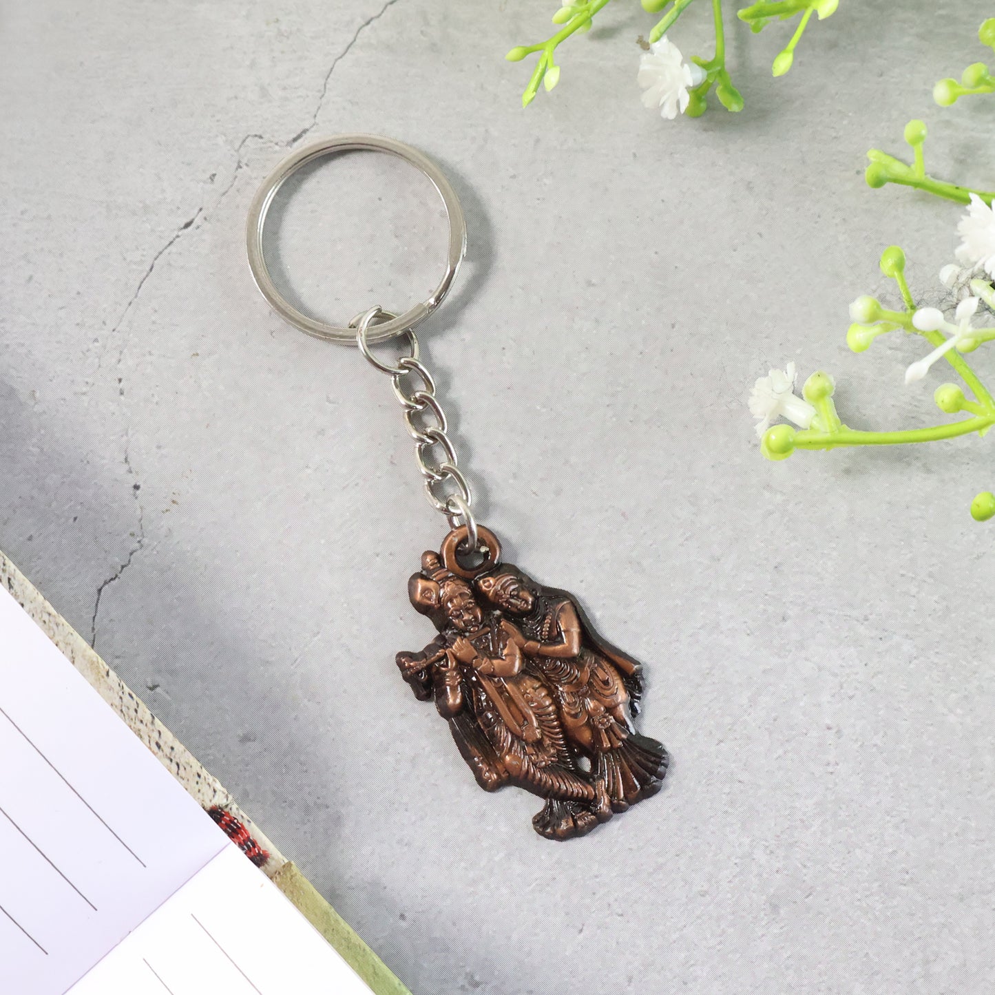 Wukusy Radha Krishna metal keychain featuring detailed religious figures on a sleek keychain design.