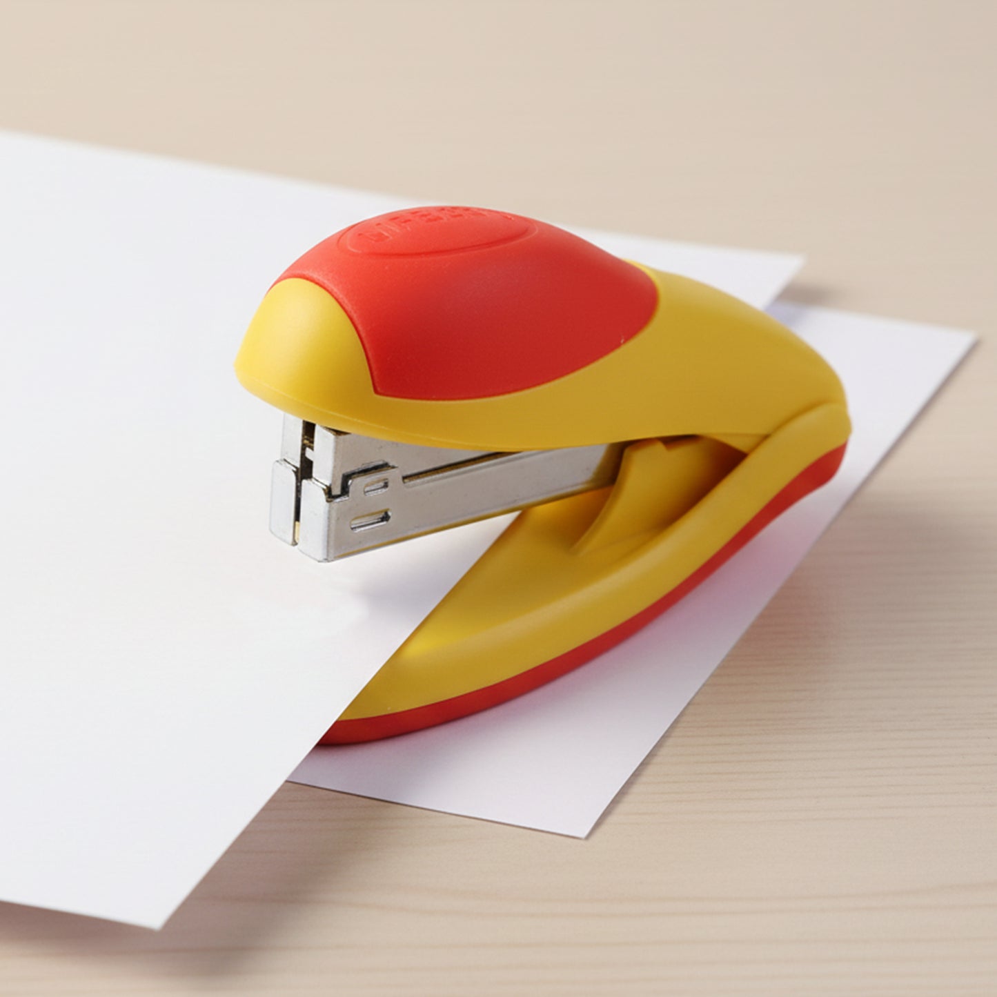 Wukusy heavy-duty desktop stapler with a set of staple pins, sturdy metal construction, and ergonomic handle for secure binding.