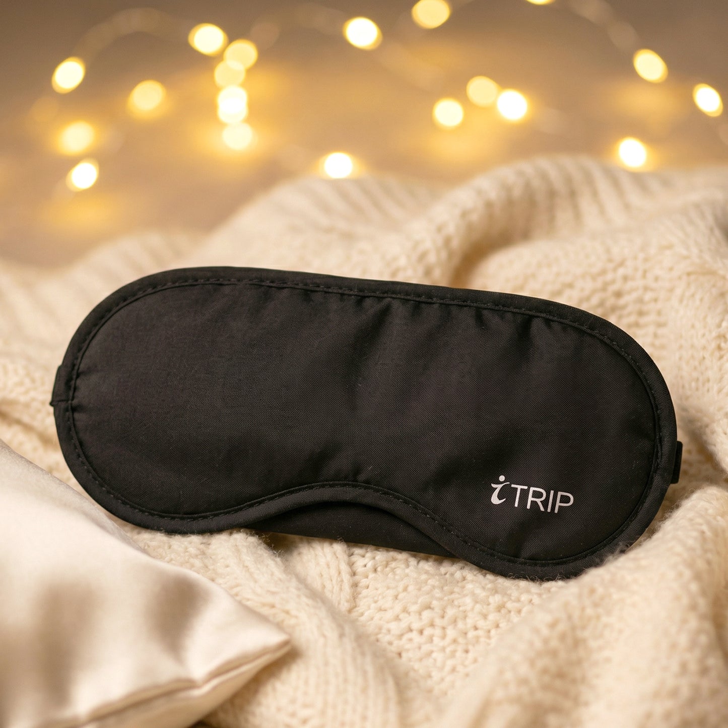 Soft padded sleep eye mask by Wukusy, designed for comfort and darkness, with a smooth fabric cover and adjustable strap.