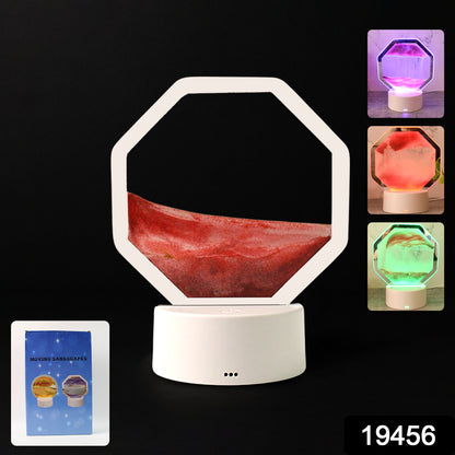 Wukusy LED moving sand art table lamp on office desk with flowing colorful sand inside a clear glass container.