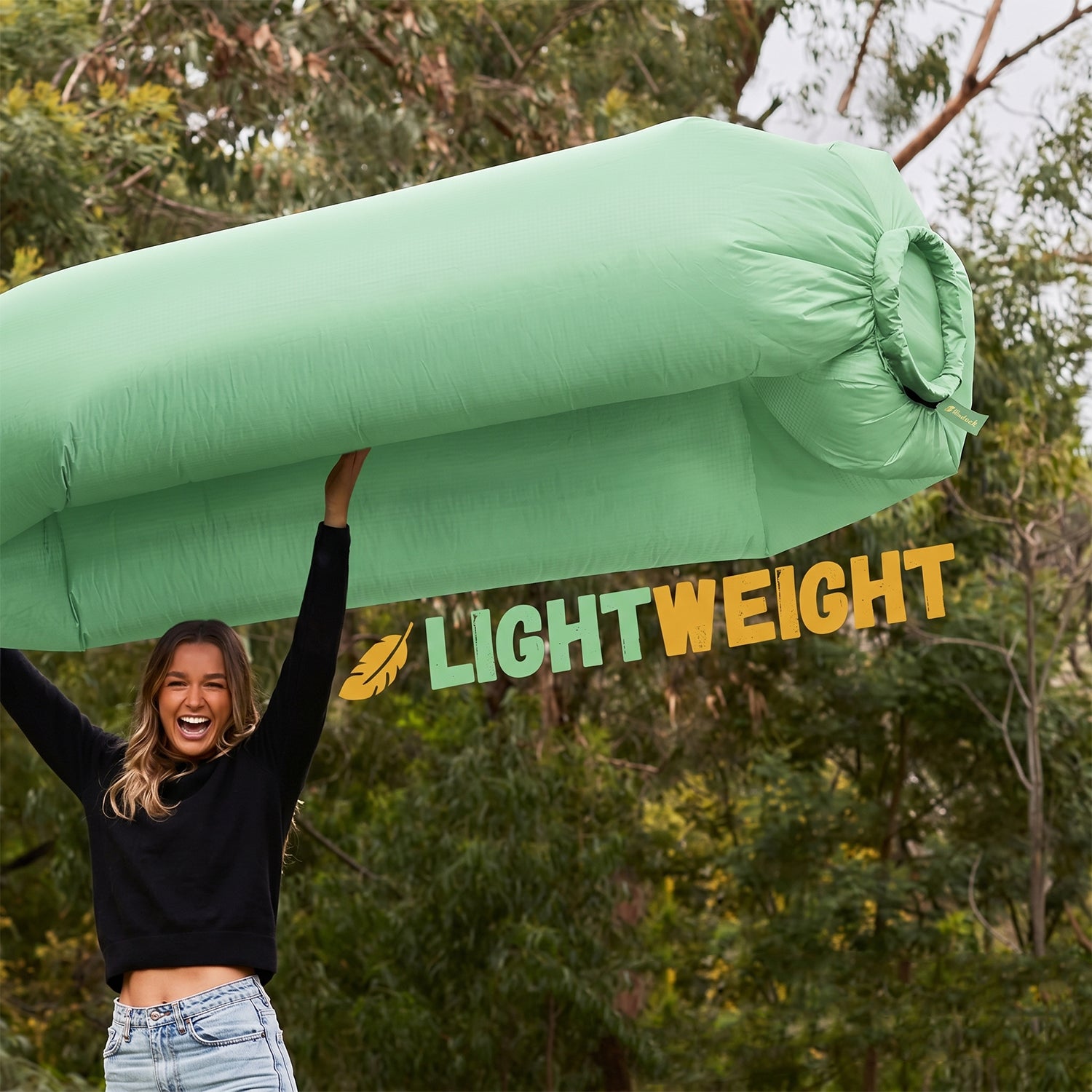 Wukusy foldable inflatable air sofa lounger laid out on grass, showcasing its portable, foldable design and comfortable seating surface.