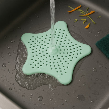 Mint green silicone star-shaped sink filter by Wukusy, designed to catch hair and debris in bathroom drain strainers.