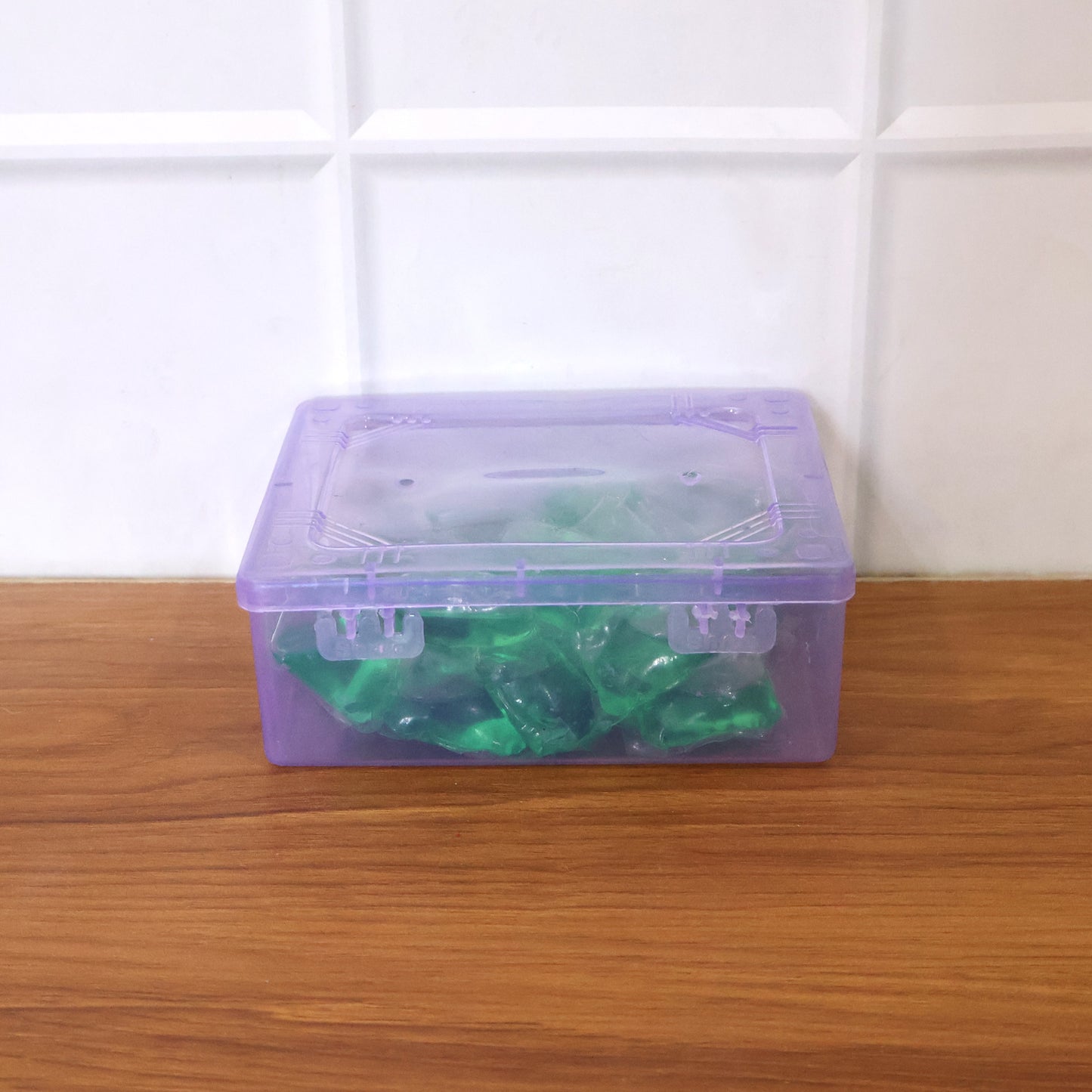 Wukusy concentrated liquid laundry detergent pods, 25-piece pack, showing clear pods filled with blue detergent.