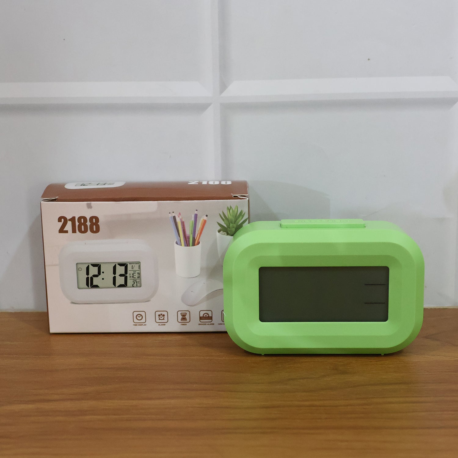 Digital alarm clock with clear LED display from Wukusy showing time and alarm settings on a sleek black device.