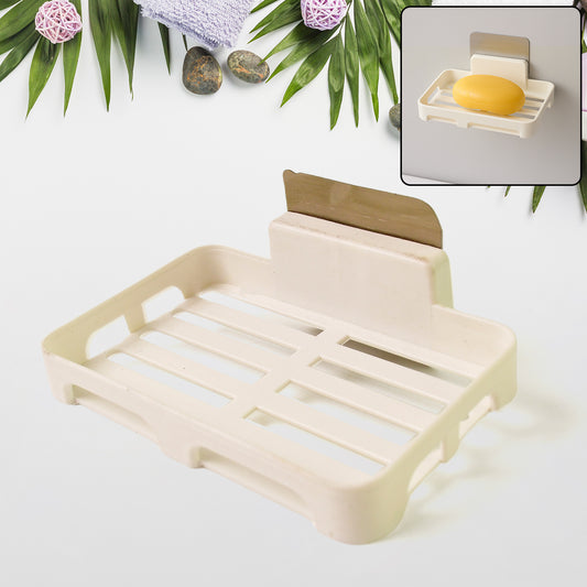 Wukusy self-adhesive plastic soap dish with drain slots mounted on a bathroom wall for convenient soap storage.