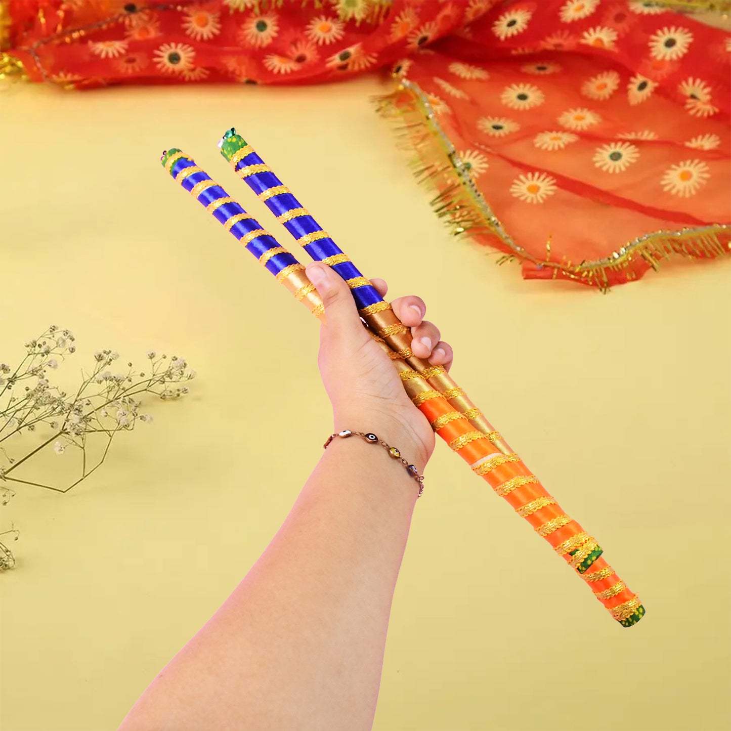 Pair of traditional decorative Dandiya sticks for Navratri Garba by Wukusy, featuring colorful designs and intricate patterns.