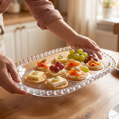 Clear glass oval serving tray with beaded edge, 9 inches, perfect for snacks, by Wukusy.