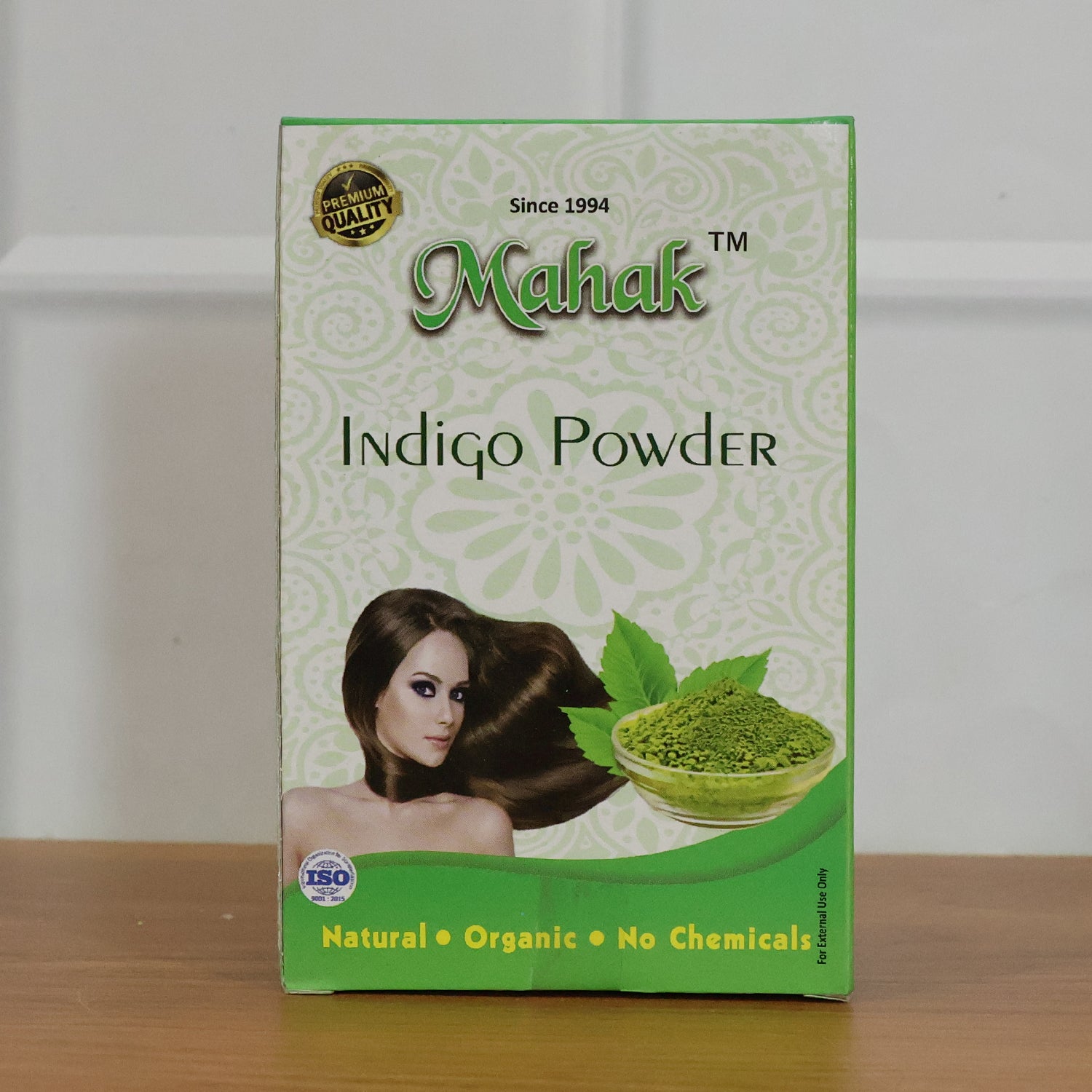 Wukusy natural indigo powder for traditional hair care, 80g, showing vibrant blue-green indigo leaves and powder in a bowl.
