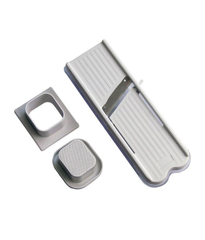 Wukusy stainless steel vegetable and dry fruit slicer and cutter showing sharp blades and sliced produce.