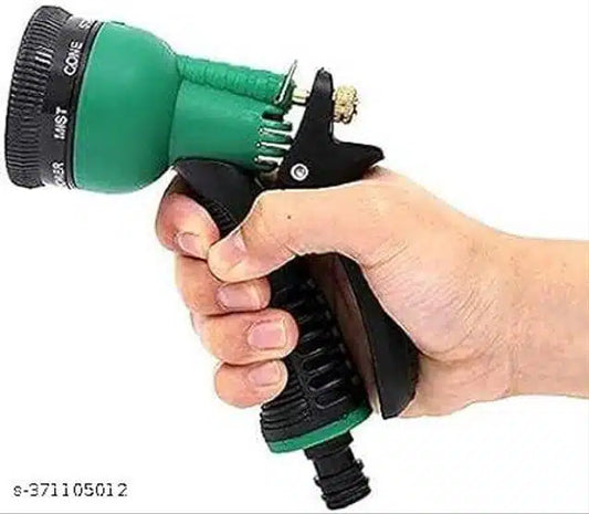 Green and black plastic garden faucet from 11853, showing a close-up of the outdoor water spigot with handle and threading.