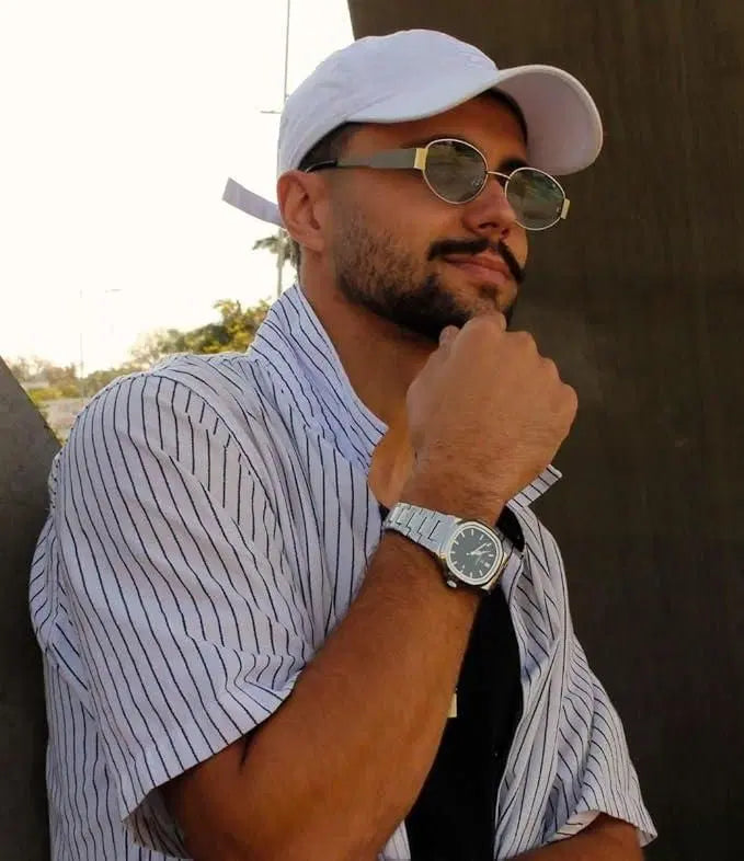 Luxury stainless steel men's analog watch by 1238 showing a sleek round dial with silver-tone finish and metal bracelet strap.
