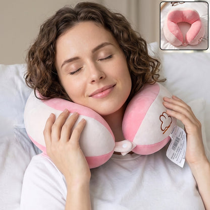 Pink plush U-shaped travel neck pillow with white accents, soft head and neck support for comfortable travel by Wukusy.