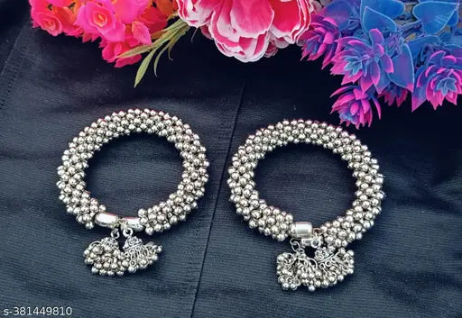 Sterling silver kada bangles in a women's jewelry set, featuring two elegant silver kada bracelets with intricate designs.