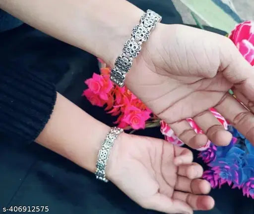 Sterling silver kada set for women, pack of 2, showcasing shiny, handcrafted silver bangles in a stylish jewelry set.