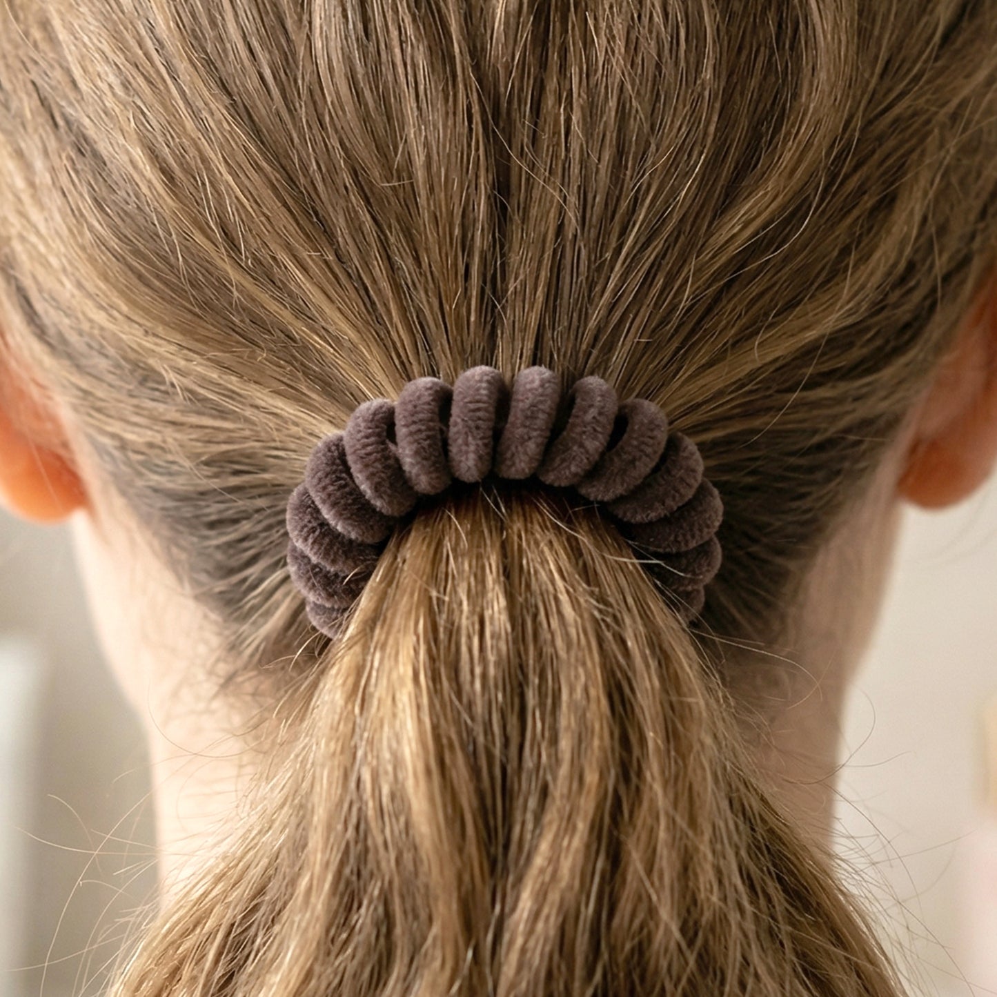 Soft stretchable telephone wire style hair band from Wukusy, shown in black with a flexible, thin design for hair styling.