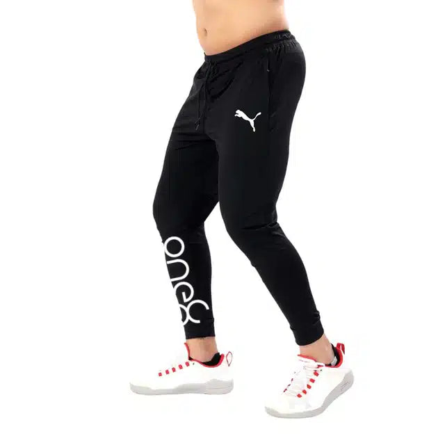 Black polyester men's track pants with a relaxed fit, featuring elastic waistband and side pockets, size 28, by 13455.
