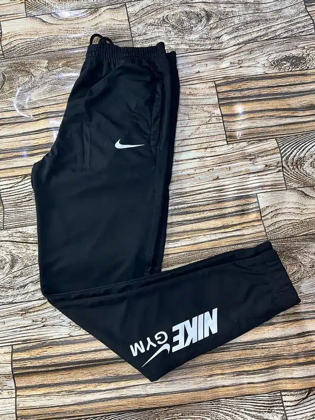 Black men's track pants by 13455 with an elastic waistband and tapered fit, size 28, suitable for sports and casual wear.