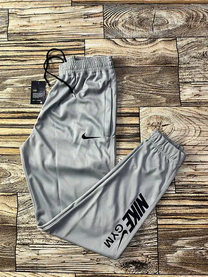 Light grey polyester men's track pants with a relaxed fit, designed for comfort and active wear, size 28.