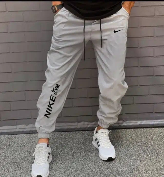 Light grey polyester men's track pants by 13455, size 28, featuring comfortable athletic design and tapered fit.