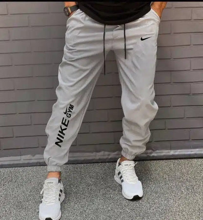 Light grey polyester men's track pants by 13455, size 28, featuring comfortable athletic design and tapered fit.