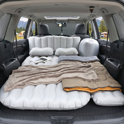 Wukusy portable car air mattress bed set with two pillows and air pump, inflated and ready for use inside a vehicle.