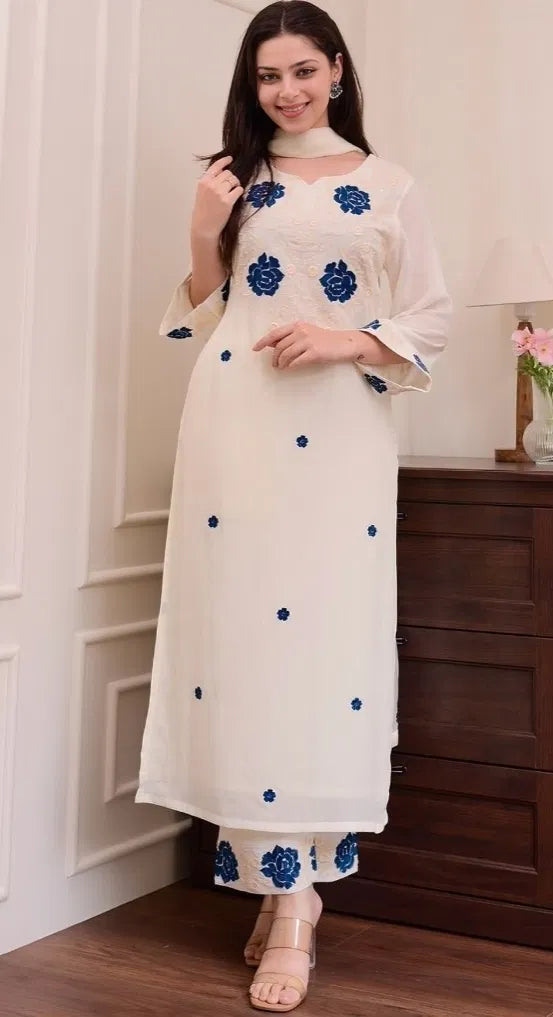 White women's kurta set with dupatta and bottomwear, featuring traditional embroidery and comfortable fit.