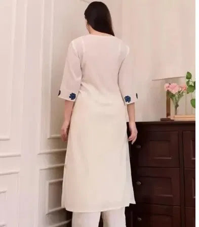 White women's kurta set with dupatta and bottomwear, featuring traditional embroidery and comfortable fit.