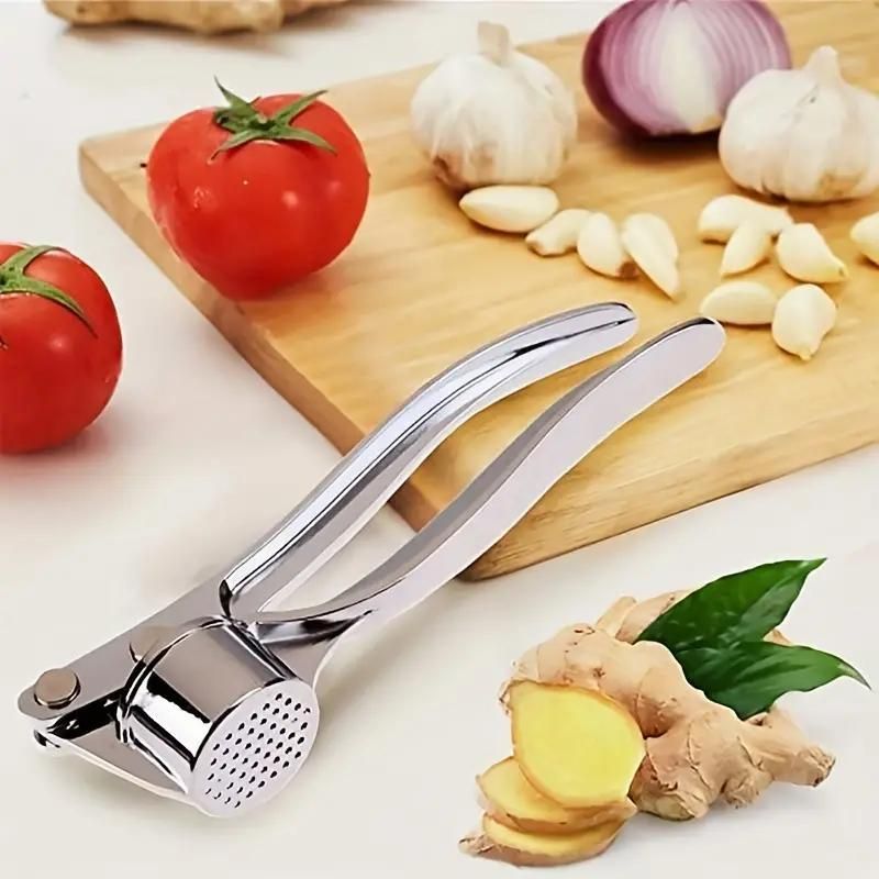 Manual aluminum garlic crusher and ginger mincer from 18057, featuring a durable design for efficient garlic and ginger crushing.