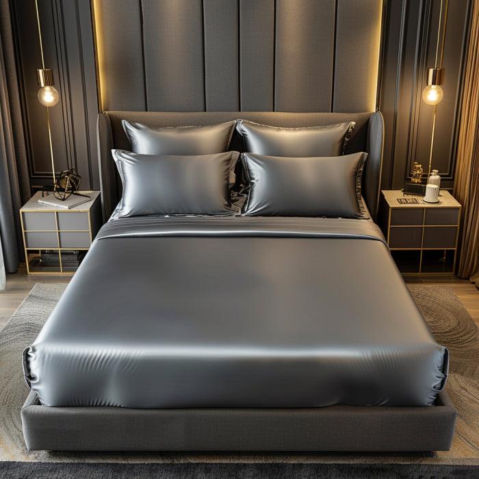 Grey satin fitted bedsheet with elastic edges and two matching pillow covers from 18214. Soft, luxurious sleep set.