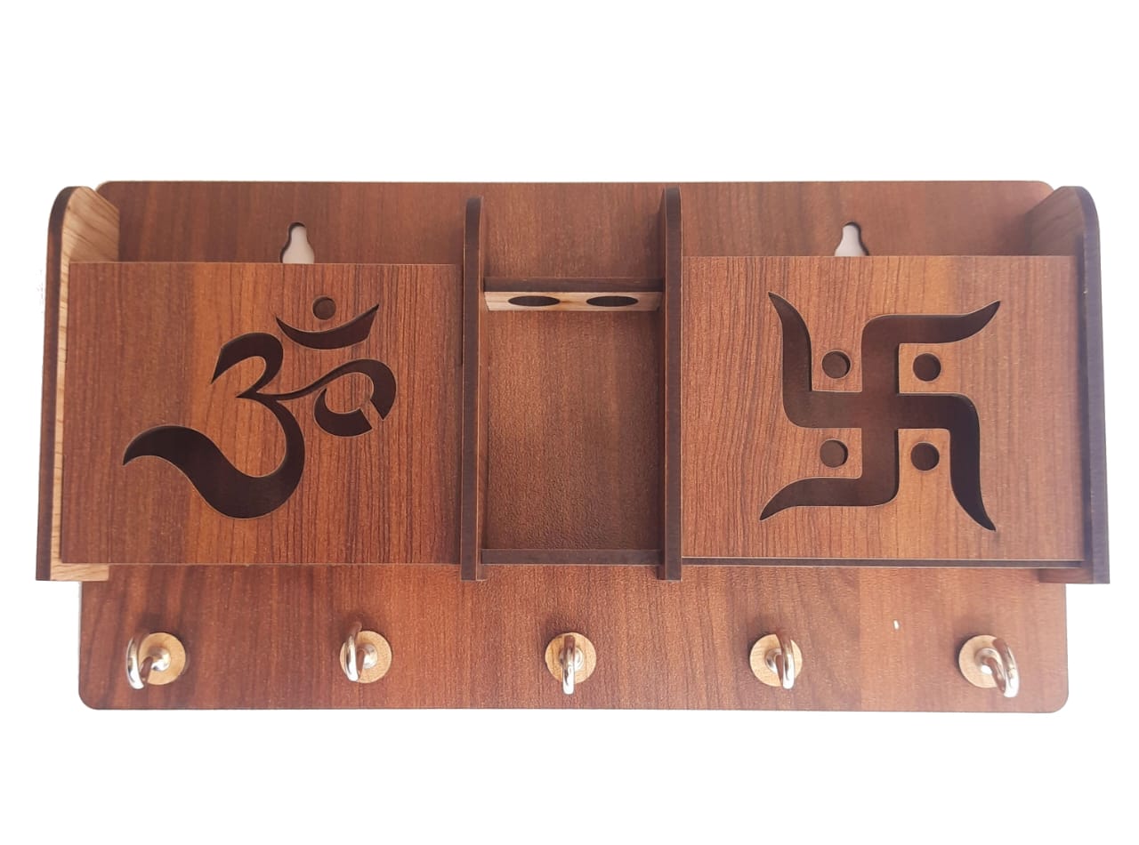 Wooden Om Swastik phone stand and keyholder with intricate carvings, featuring a natural finish and compact design.
