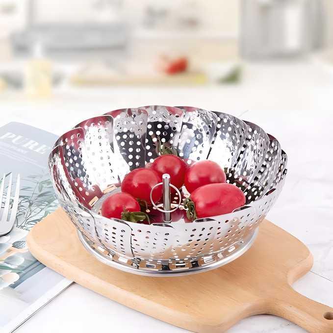 Stainless steel steamer basket for vegetables and seafood with safety tool, ideal for steaming and idli making in the kitchen.