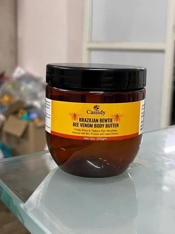 Brazilian Beewtie Bee Venom Body Butter by 13373, creamy texture in a jar, natural ingredients for skin nourishment.