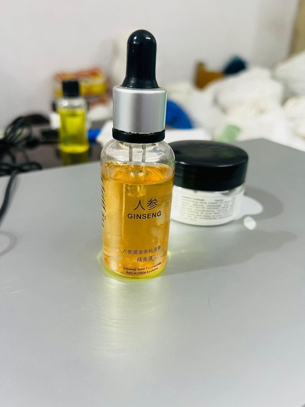 Ginseng Gold Polypeptide Anti-Ageing Serum massage oil bottle with 30 ml capacity, featuring gold accents and a sleek design.