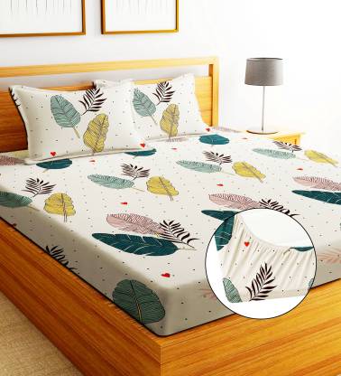 Cream-colored 750 bedsheet with soft fabric and subtle floral pattern, neatly spread on a bed for a cozy bedroom look.