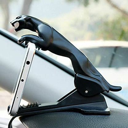 Jaguar car mobile holder attached to slot car racing track, compatible with race track accessories and designed for easy phone mounting.