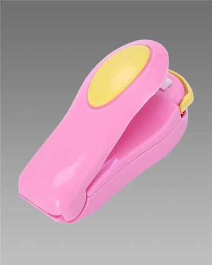 Multicolour portable small heat sealer machine for food storage, sealing plastic, snack, and vacuum bags in kitchen tool set.