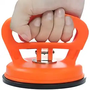 Black dent puller suction cup from 19378 kitchen tool set, used for removing dents from surfaces and appliances.