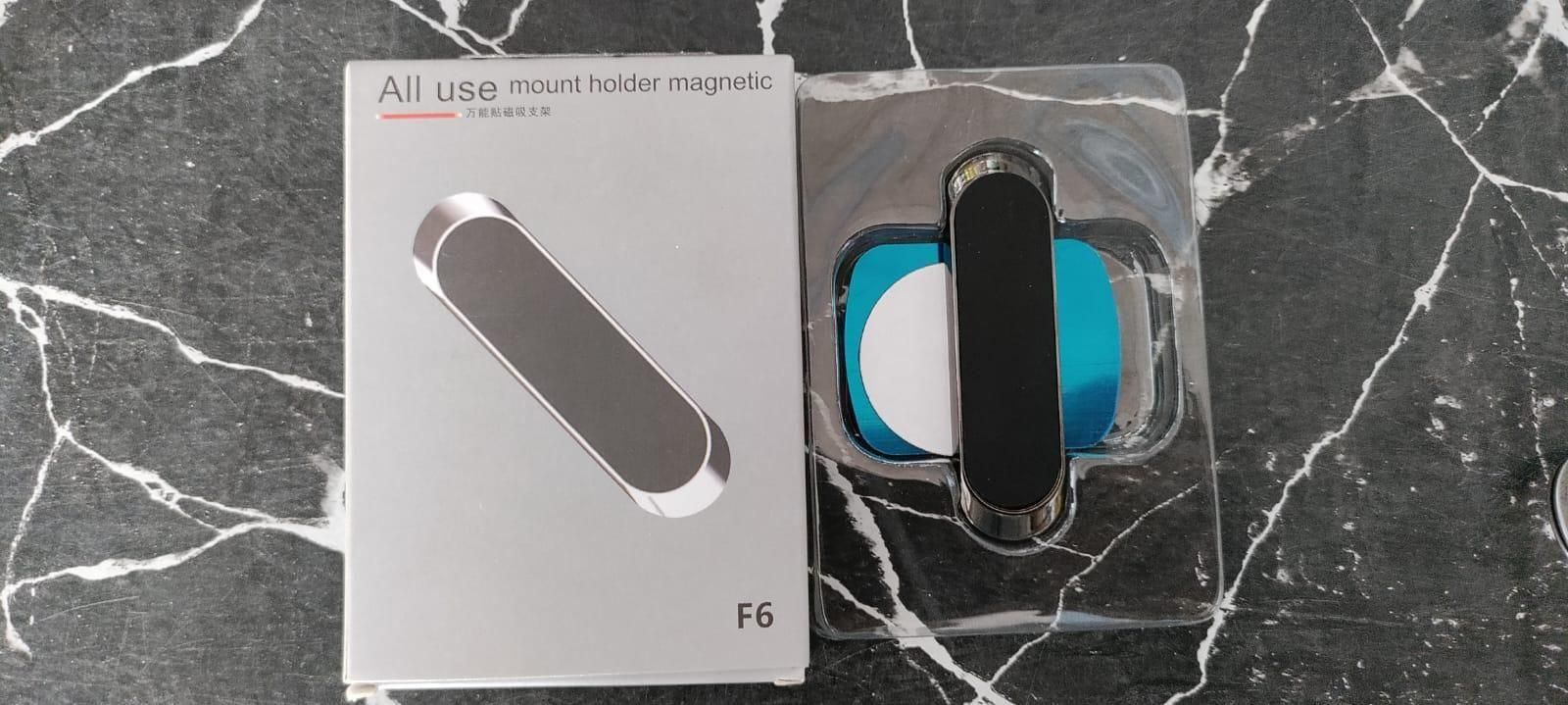 Magnetic car phone holder dashboard mini strip shape stand, compact design for secure phone mounting in vehicles.