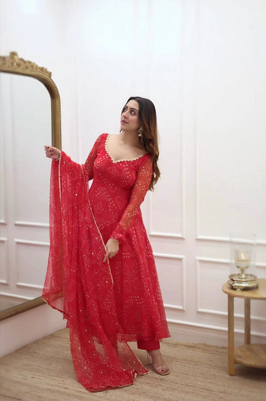 Women’s red Bandhani style gown from brand 19198, featuring traditional patterns and flowing fabric, shown on a model.