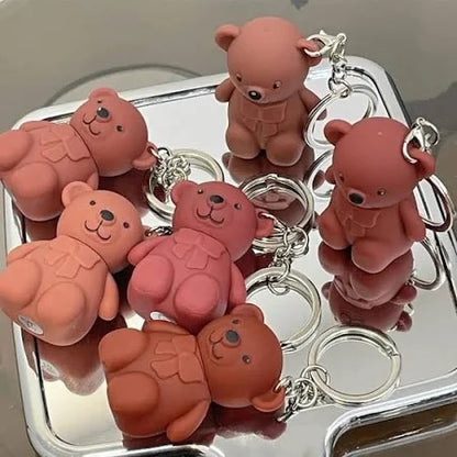 Six multicolored 19203 lipsticks with bear keychain, creamy matte texture, long-lasting formula, ideal for makeup and lip tint.