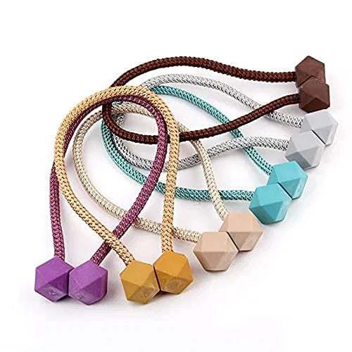 Magnetic curtain tieback clip in multicolor with small bead design, used to hold and style curtains securely.