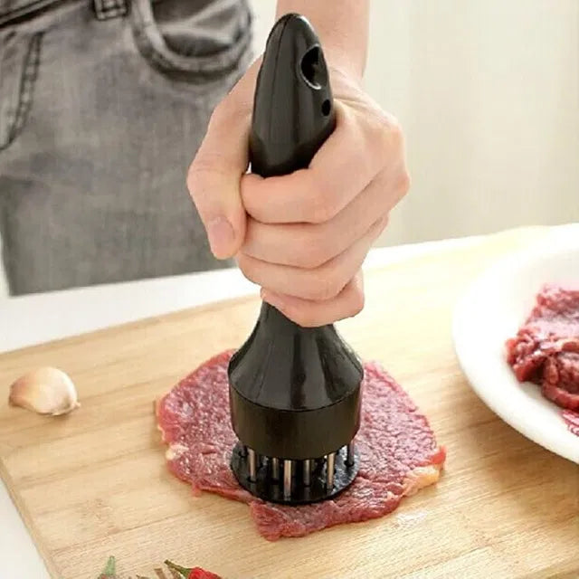 Stainless steel needle prong meat tenderizer kitchen tool from 19357, part of a kitchen tool set, with textured handle and prongs for tenderizing.