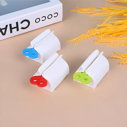 Set of four portable toothpaste dispensers with rolling squeeze mechanism, perfect for bathroom use and manual toothpaste application.