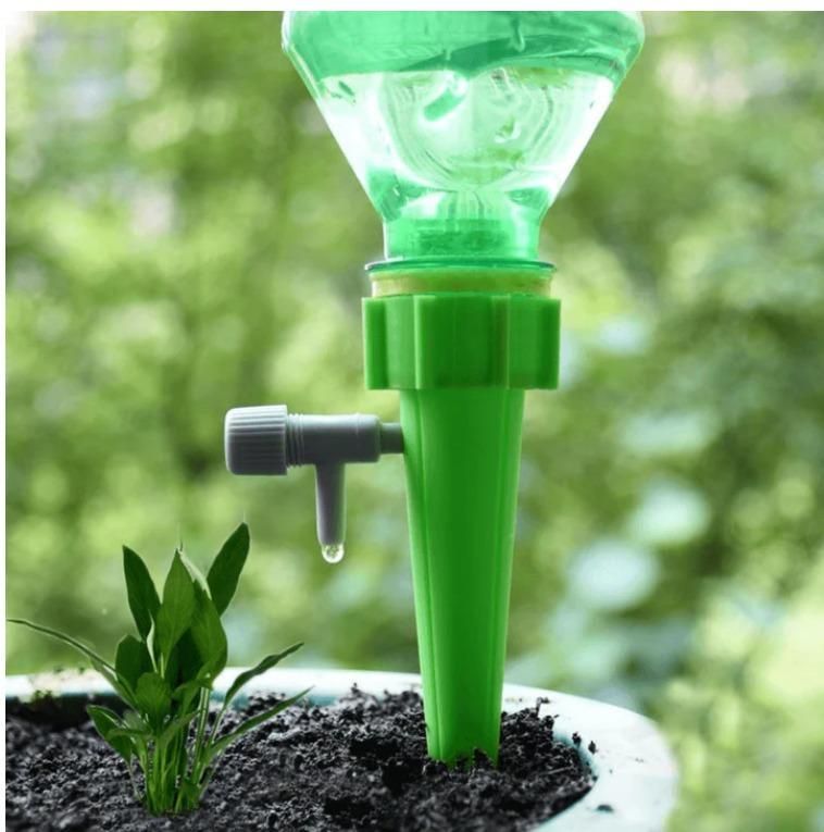 Set of five adjustable self-watering spikes for kitchen plant care, designed to automate watering in garden or indoor pots.