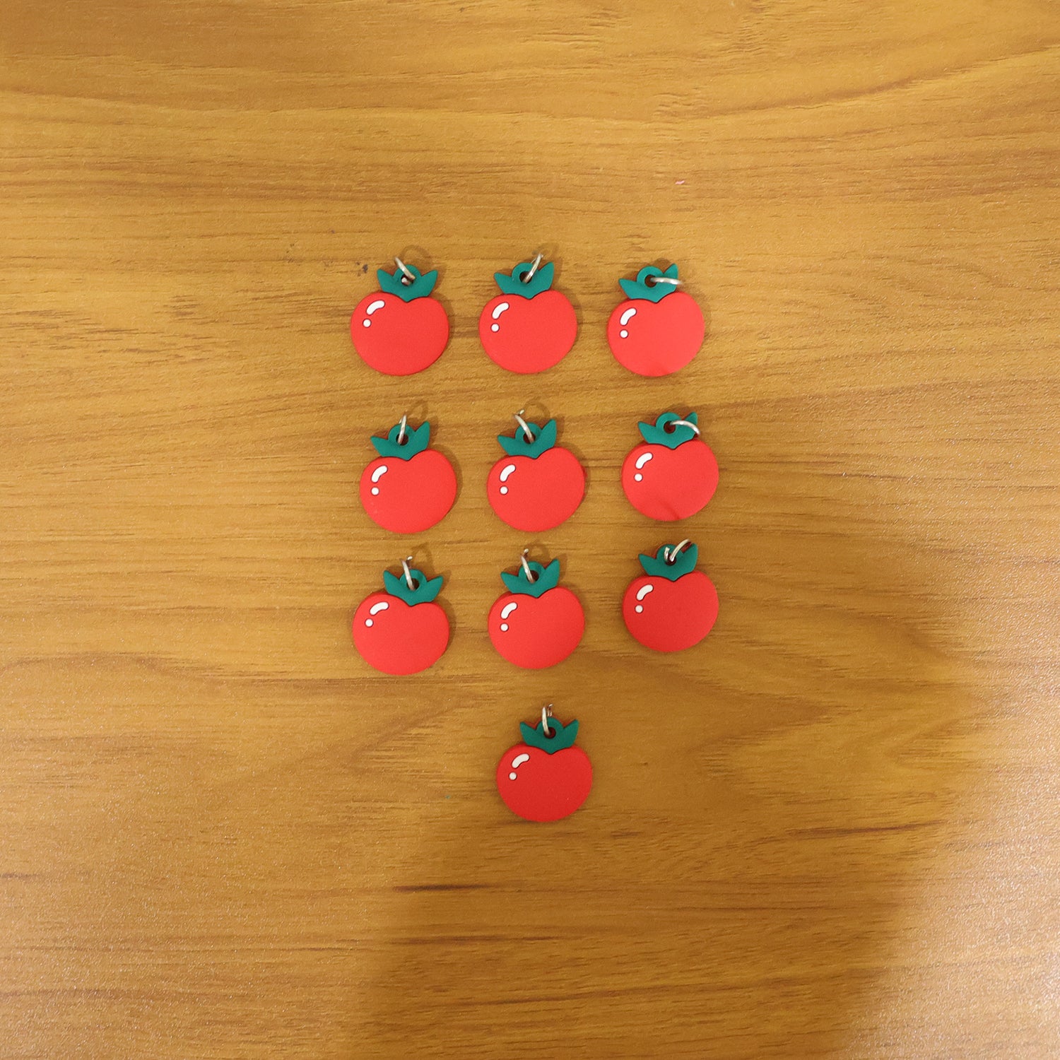 Set of 10 cute red apple-shaped bag charm keychains by Wukusy, featuring vibrant apple designs and keyring attachments.