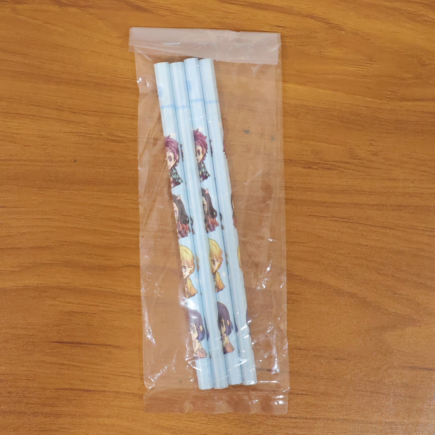 Set of four Wukusy cartoon printed pencils for kids, featuring colorful cute designs for school writing and drawing.