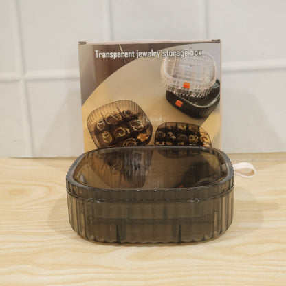 Stackable Wukusy plastic jewelry organizer box with multiple compartments for rings and small accessories, shown stacked in the image.