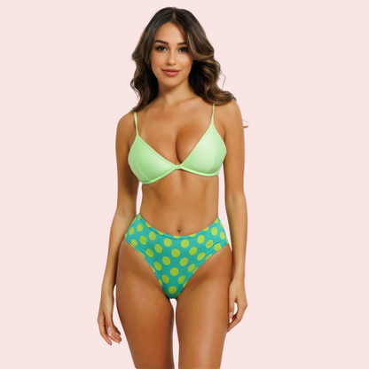 High-waisted green polka dot bikini bottom by Snazzyway, featuring retro style and flattering fit for beachwear or poolside lounging.